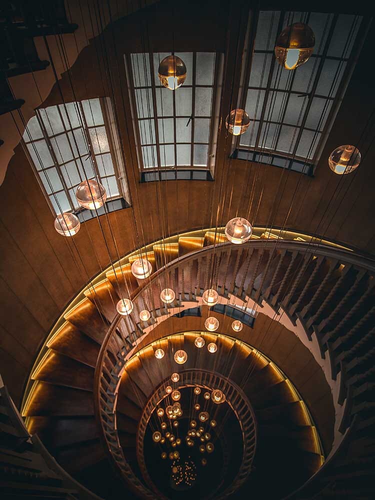 Cast Crystal Sphere Cascade Chandelier above a staircase