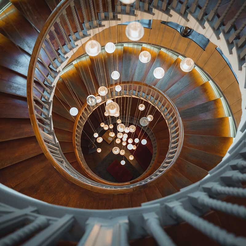 Cast Crystal Sphere Cascade Chandelier above a staircase