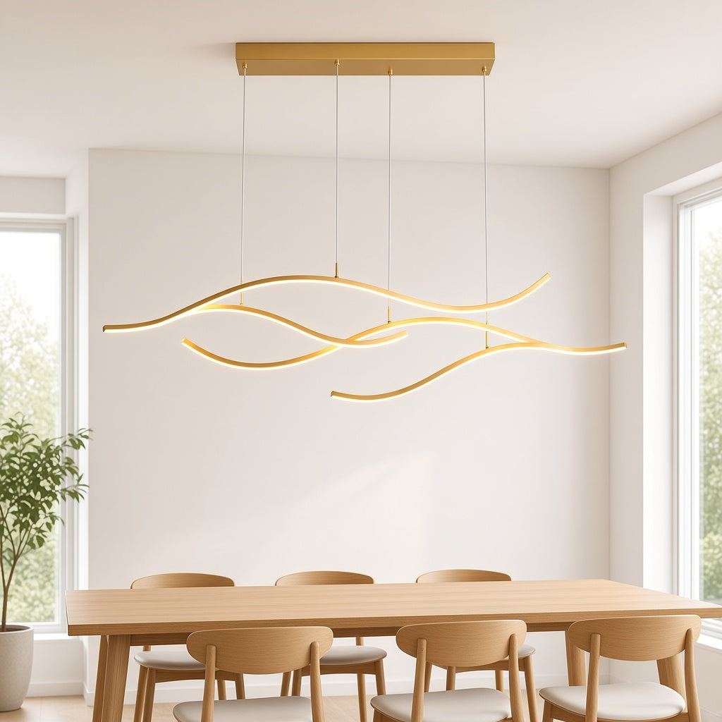 Gold Wave LED Linear Chandelier above a dining table