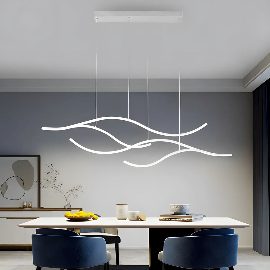 Gold Wave LED Linear Chandelier above a dining table