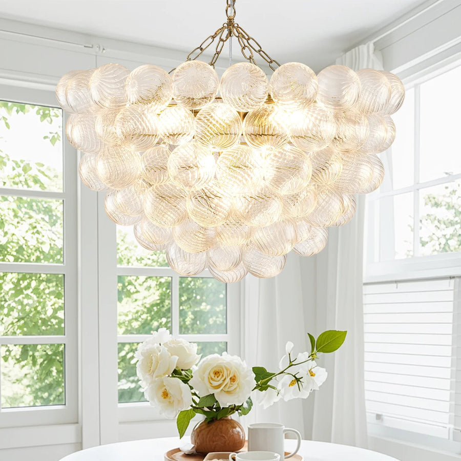 Ribbed Glass Globe Gold Chandelier above a dining table