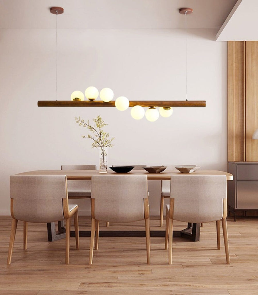 Walnut and Glass Ball Linear Chandelier above a dining table